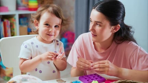 Woman and Toddler Daughter Play with Clay at Home