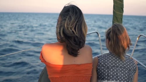 Mother and daughter enjoying summer sailing trip on a yacht in Greece super slow motion