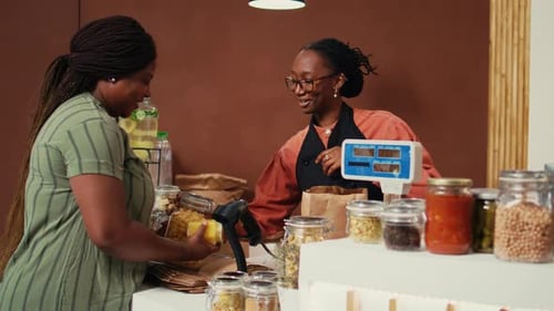 Women Working Behind The Counter at Local Store