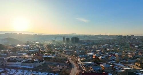 Aerial view A snowy Yerevan Armenia cityscape with a few houses and a few cars