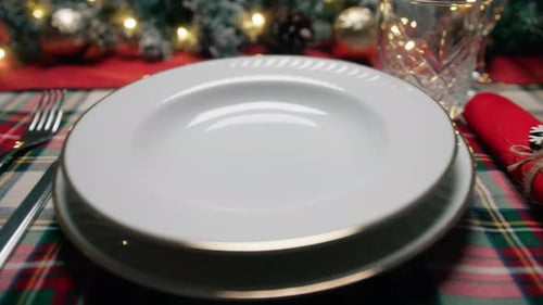 Setting Christmas Table with Plates and Silverware
