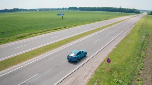 Beautiful audi car on empty highway. Blue electric automobile moving on a road.