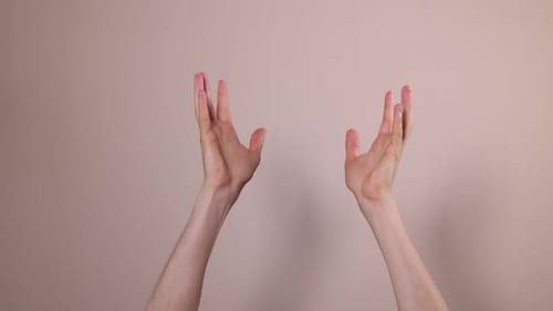 Hands Reach Upward Against a Light Background