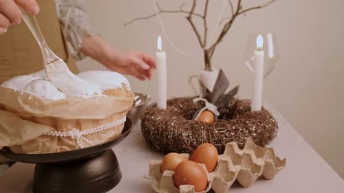 Woman Decorating Easter Cake with White Icing