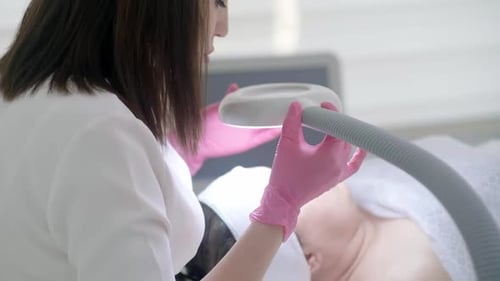 Woman Doctor Performs Cosmetic Procedure on Patient