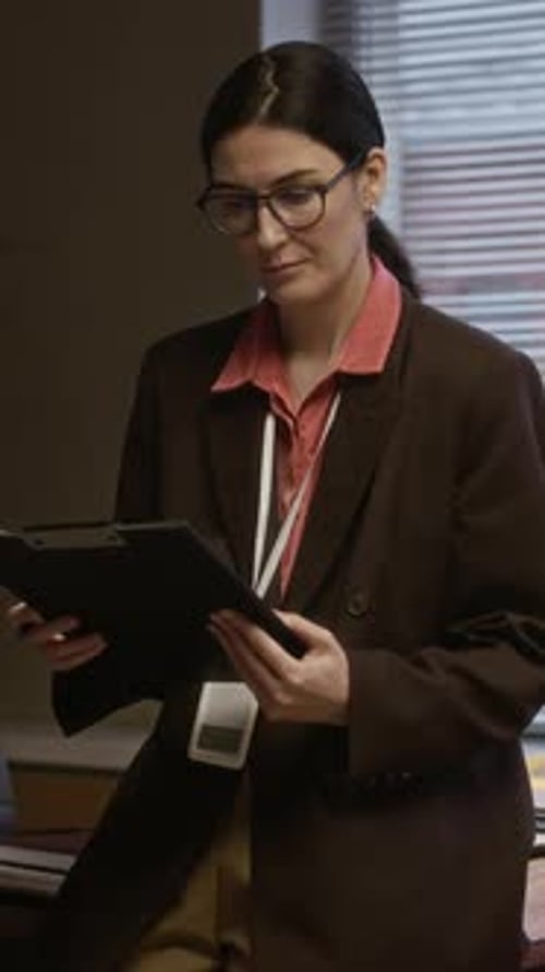 Female Counselor Reviewing Document in Office