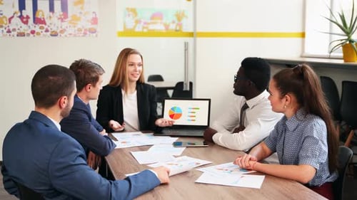 Team Discussing Data and Graphs in Meeting