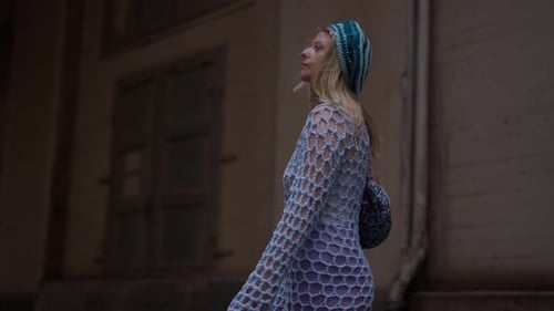 Stylish Woman Walks in Urban Alleyway