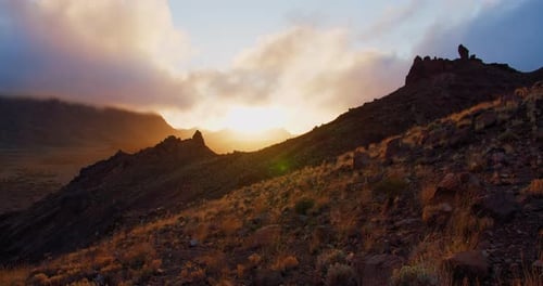 View of a beautiful sunset over scenic mountain ranges. Golden hour, clouds above Teide National Par