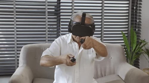 Senior Man Using Virtual Reality Headset on Couch