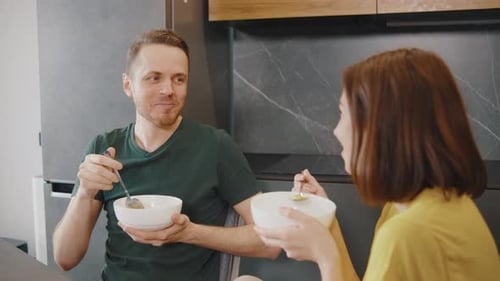 Couple Enjoying Meal Together in Kitchen