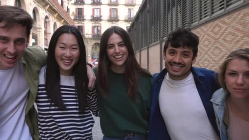 Smiling Young Adults Standing Together on Urban Street