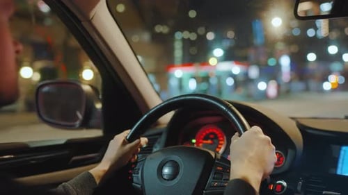 Man Driving Car Through the Streets of Night City