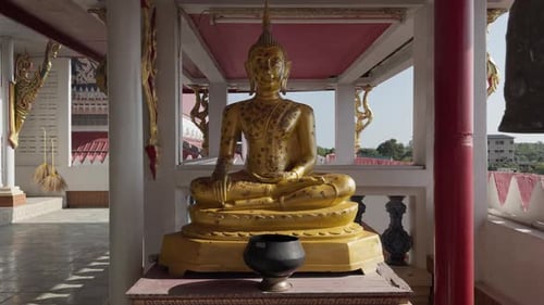 Golden Buddha statue in Thai temple, push in shot, spiritual Buddhism Thailand