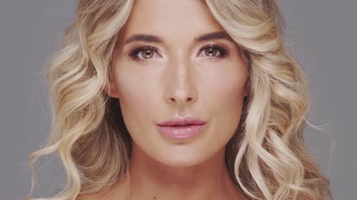 Studio Portrait of Young and Beautiful Blond Woman Over Grey Background Skin Care and Wellness