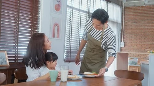 Family Eating Breakfast Together in Home Kitchen