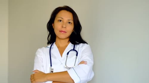 Slow Motion Close Up of a Beautiful Young Woman Lady Doctor Looking at Camera Concept of Profession