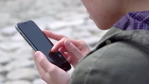 Person Using Smartphone in Urban Close-Up
