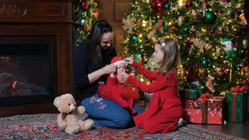 Festive Family Gathered by Christmas Tree at Home