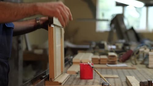 a Carpenter Makes a Part From Wood a Carpenter Hits a Wooden Part with a Hammer