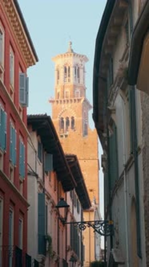 Italian Narrow Street with Historic Colorful Buildings and Lamberti Tower in Verona Old Town Veneto