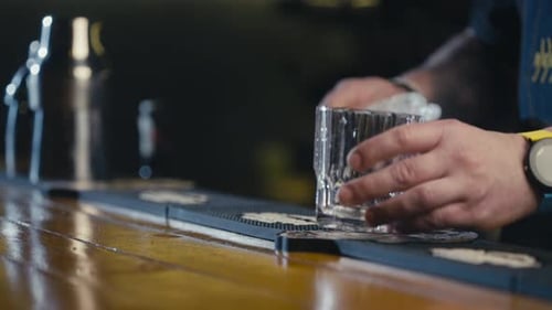 Bartender Prepares Drink with Ice in Glass