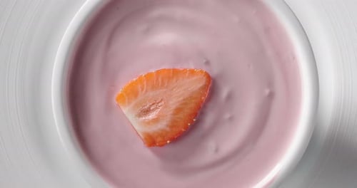 Strawberry Slice in Pink Yogurt in White Bowl