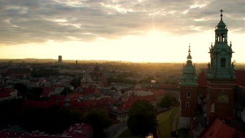 Slow aerial forward shot of Krakow City at sunrise with historic church in the morning,Poland