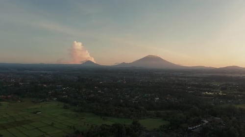 Magical morning sunrise above Ubud with mount Agung and Abang on horizon, aerial