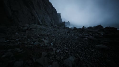 Rough Shoreline Terrain with Textured Rocks During Sunset Shadows
