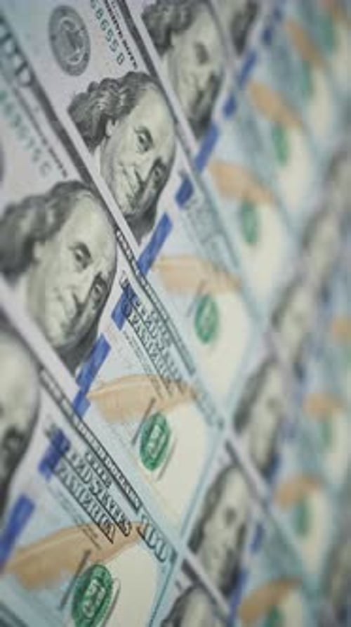 Vertical Screen Dolly Shot of US Dollar Bills Lying in Row