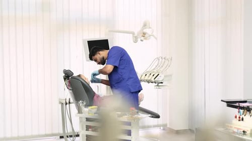 Dentist Working on Patient in Bright Office