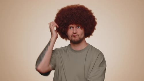 Man with Afro Looks Up Thoughtfully