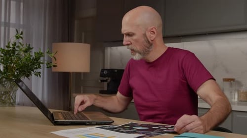 Man Working from Home Explaining Charts