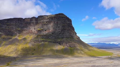 CloseUp Aerial View of Towering Cliff on Icelandic Plateau Highlighting Rugged Natural Beauty