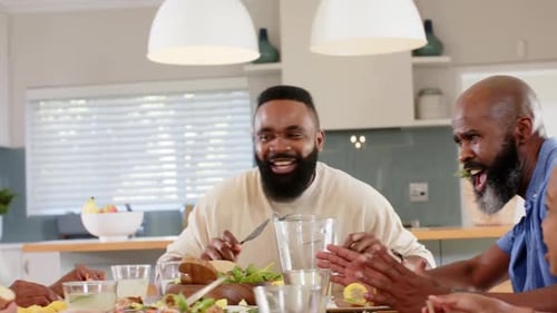 Group of Friends and Family Eating at Home