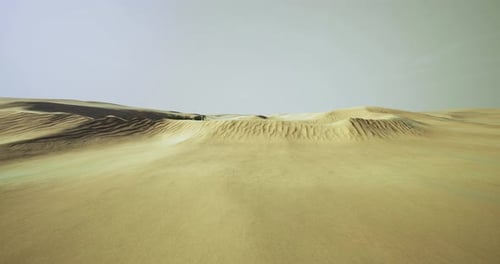 Expansive Desert Landscape Under Bright Sky with Sandy Waves and Dunes