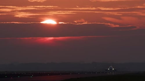 Airplane Taking off at Beautiful Sunset