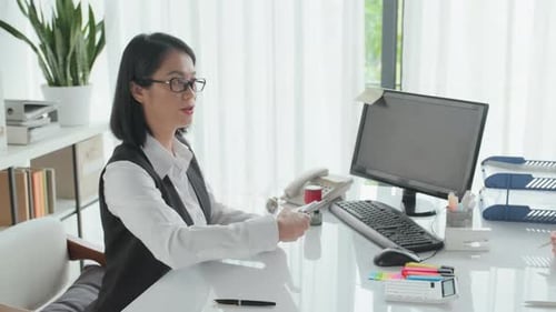 Asian Female Insurance Agent Giving Policy to Married Couple