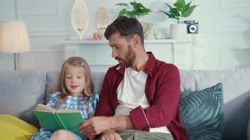 Dad and Daughter Reading a Book Together