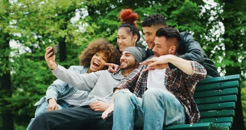Friends Taking Selfie on Park Bench Smiling