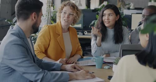 Diverse Business Team Men and Women Talking Enjoying Cooperation in Coworking Center