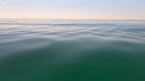 Meereswasseroberfläche, niedriger Winkel, Blick über klares azurblaues Meerwasser, Sonnenblendung, abstrakter nautischer Sommerozean