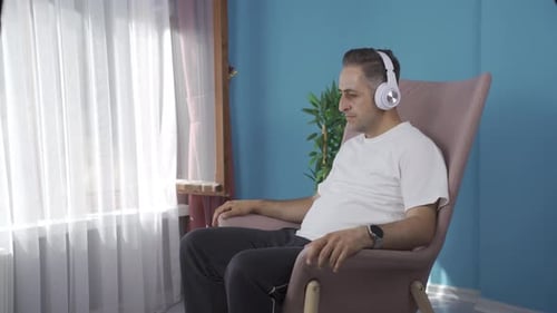 Man Relaxing at Home Listening to Music