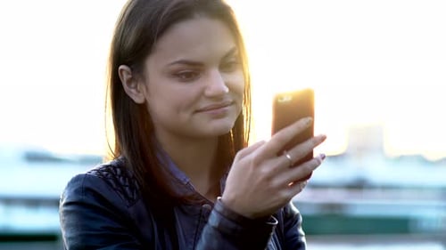Young Beautiful Caucasian Woman Using Smart Phone in the City