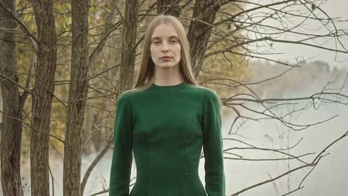 Woman modeling green dress posing in nature