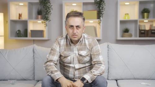 Man looking negative at camera.