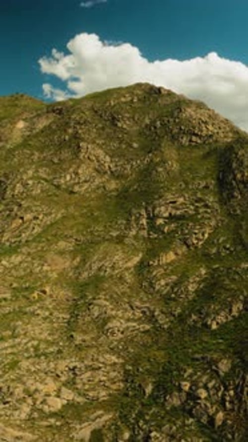Steep Rocky Mountain Peak at Glowing Sunlight Aerial View