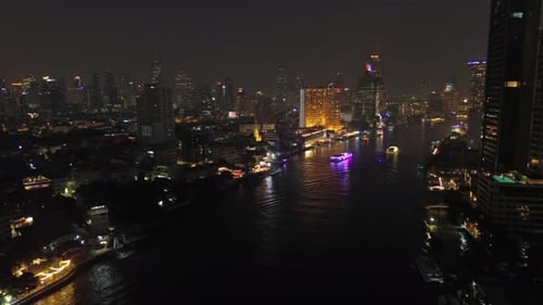 Skyscrapers in Bangkok city and river at night