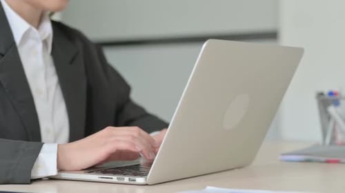 Close Up of Young Businesswoman Working on Laptop